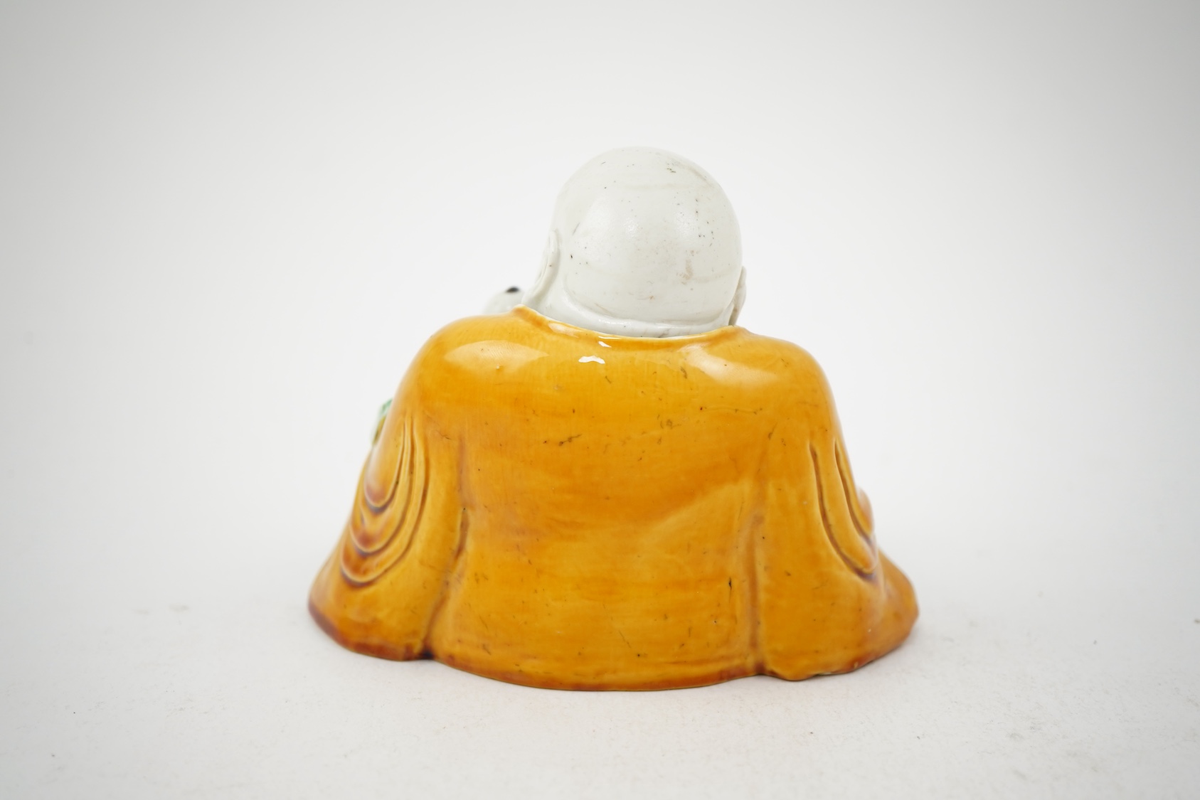 A Chinese sancai glazed biscuit group of Budai and three boys, 19th century